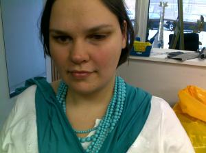 A picture of me with a turquoise fabric sample draped around my neck 